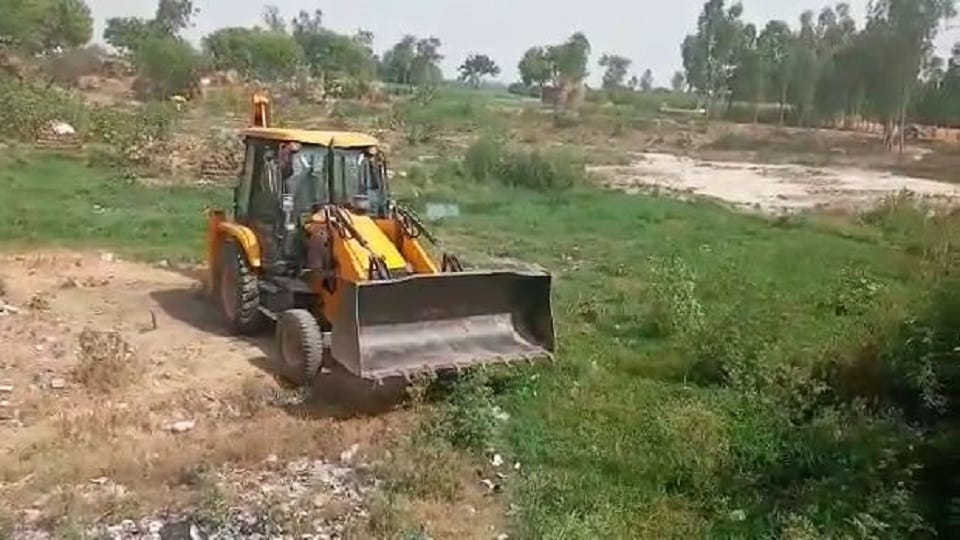 Bulldozers run to remove illegal occupation from pond land in Majhola village Kasganj 