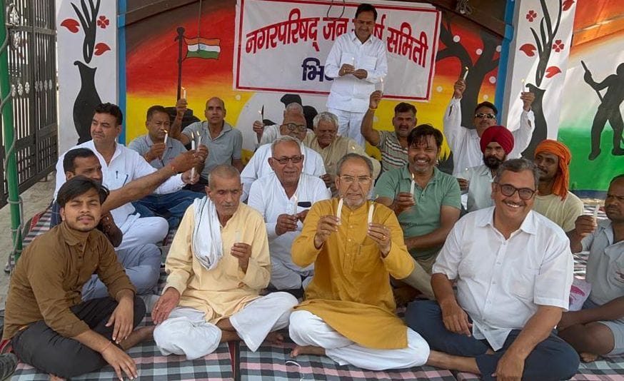 Slogans by lighting candles outside the city council against the scam