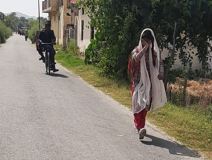 School children reaching home after noon in the scorching sun