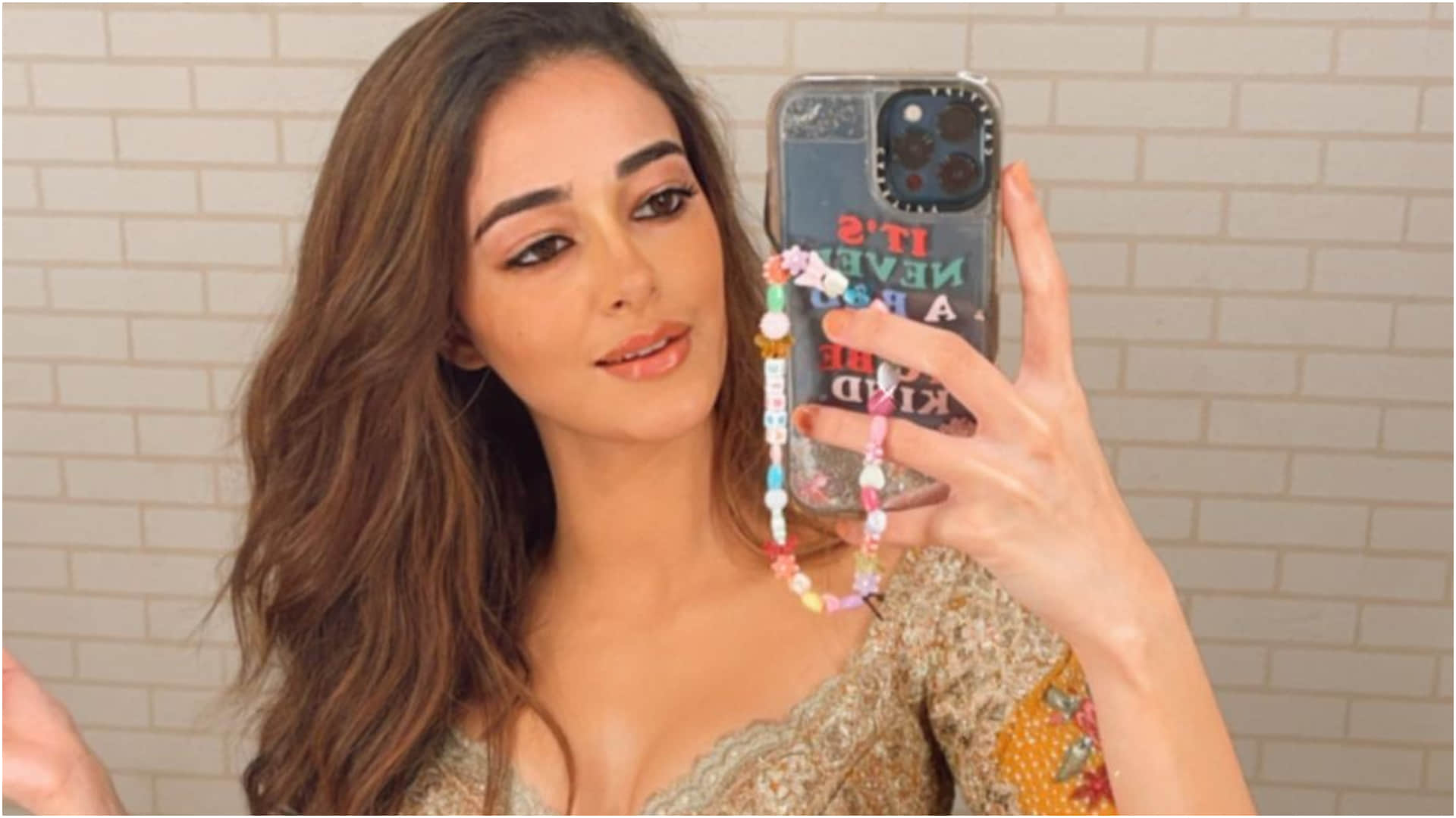 ananya pandey taking mirror selfie flaunts slim waist in mustard lehenga