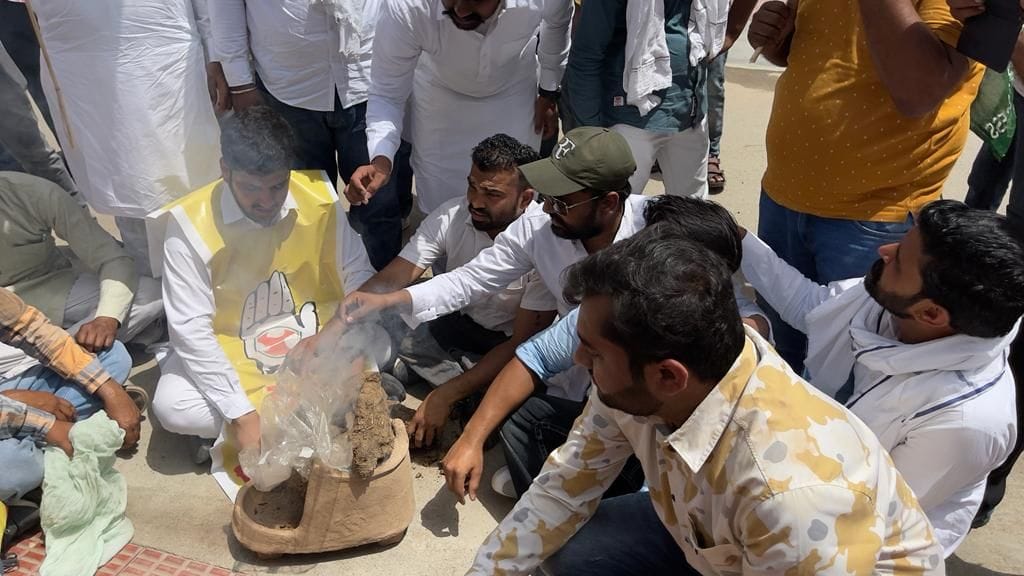 Youth Congress workers demonstrated outside the MP's residence burning the stove