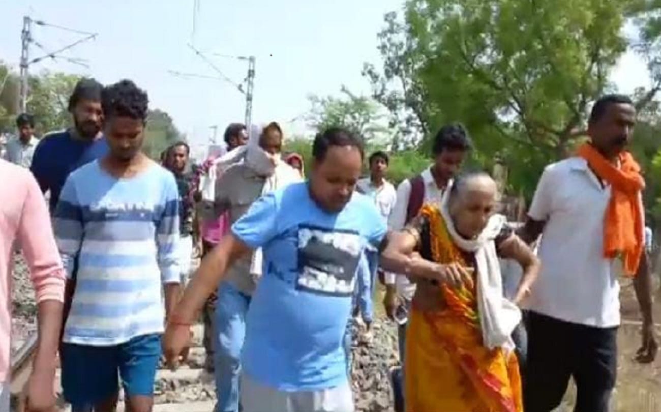 train passed over old woman who lying on railway track to commit suicide in varanasi people were surprised to see alive