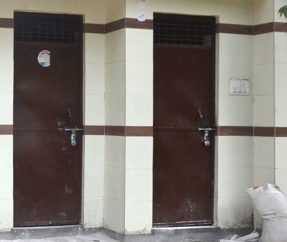Locks hanging on public toilets somewhere, dirty somewhere