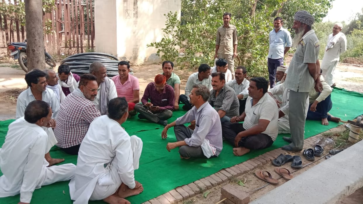 Villagers sitting together with JE and SDO staged a sit-in