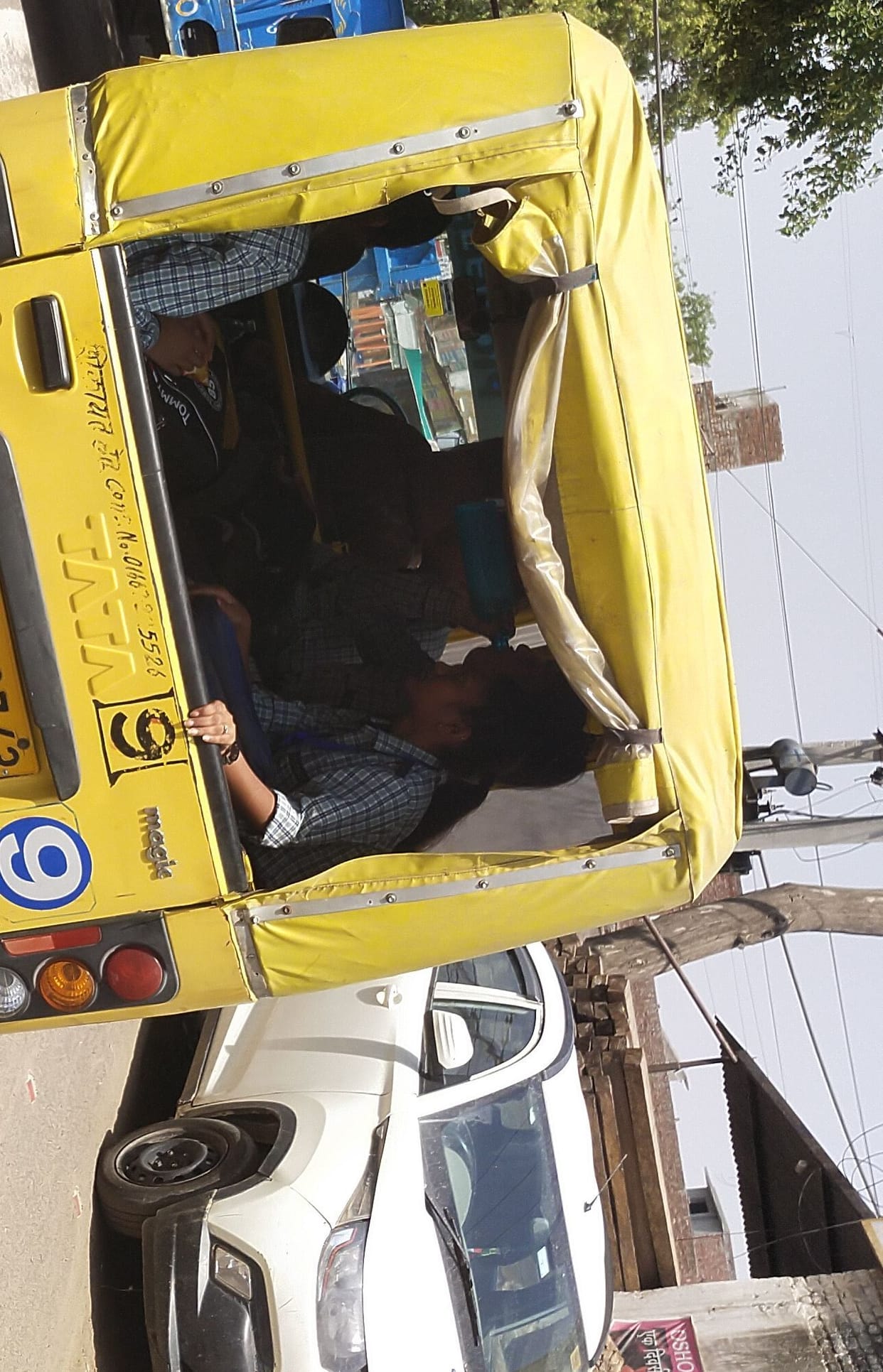 No school name, number plate missing, students carrying them in van