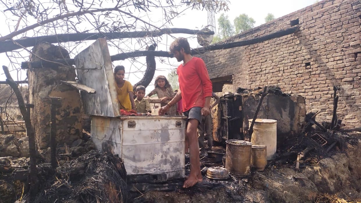 Thatched house burnt by fire, animals scorched
