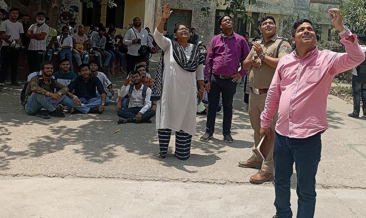 Students of Deendayal Kaushal Kendra climb on the roof of Rudrapur College