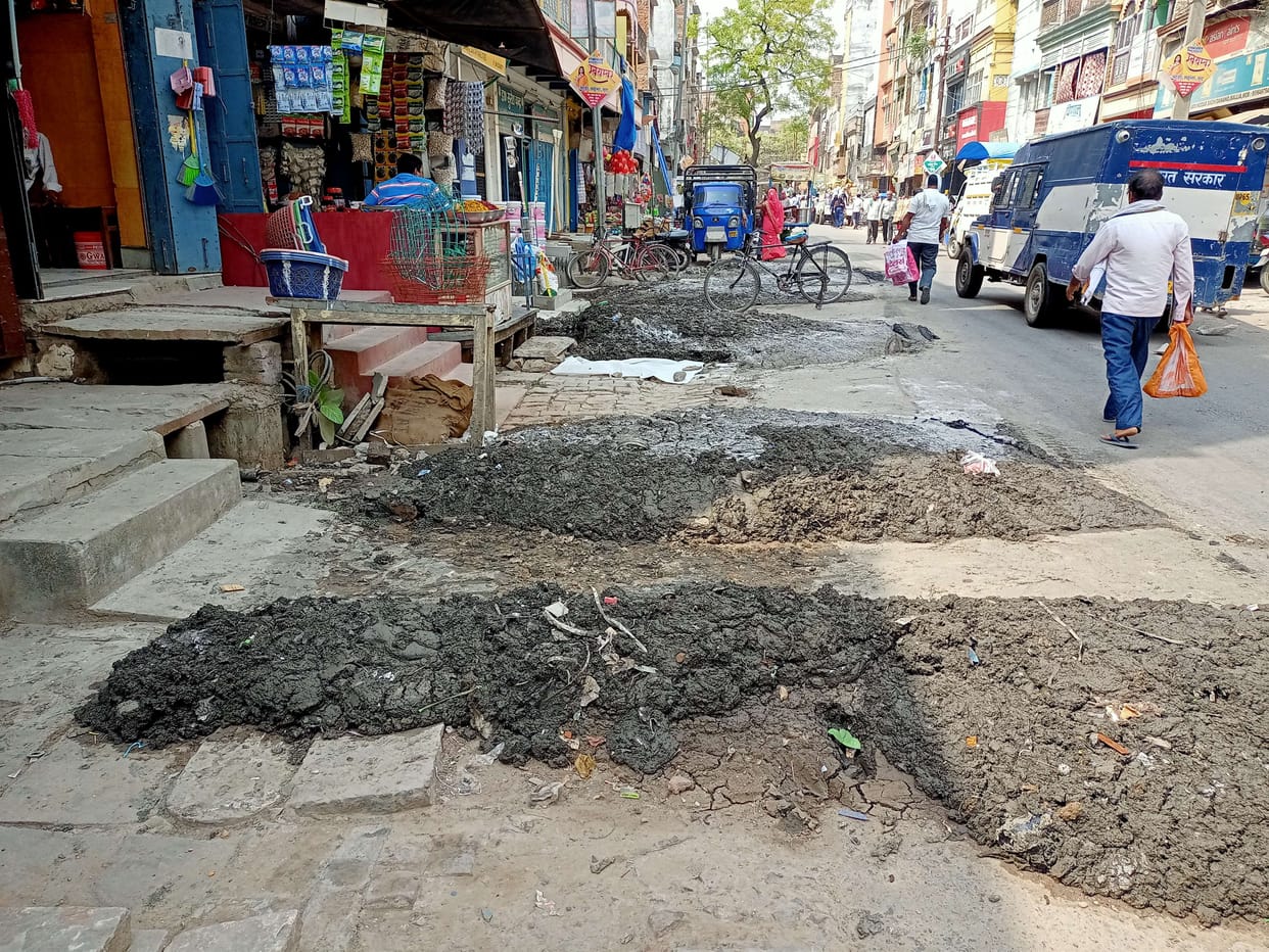 Silt of drain on the road, people upset