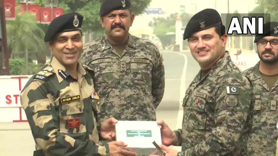 Border Security Force and Pakistan Rangers exchange sweets at JCP Attari border on occasion of Eid Ul Fitr