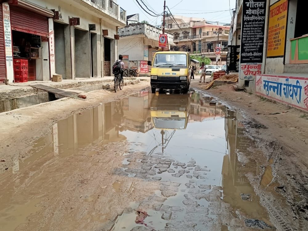 People hesitate on potholed roads