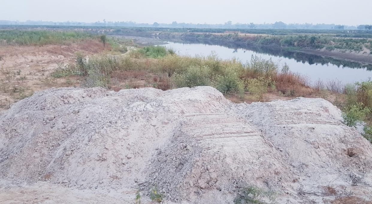 The sand being dumped on the banks of the Kali river, piled up