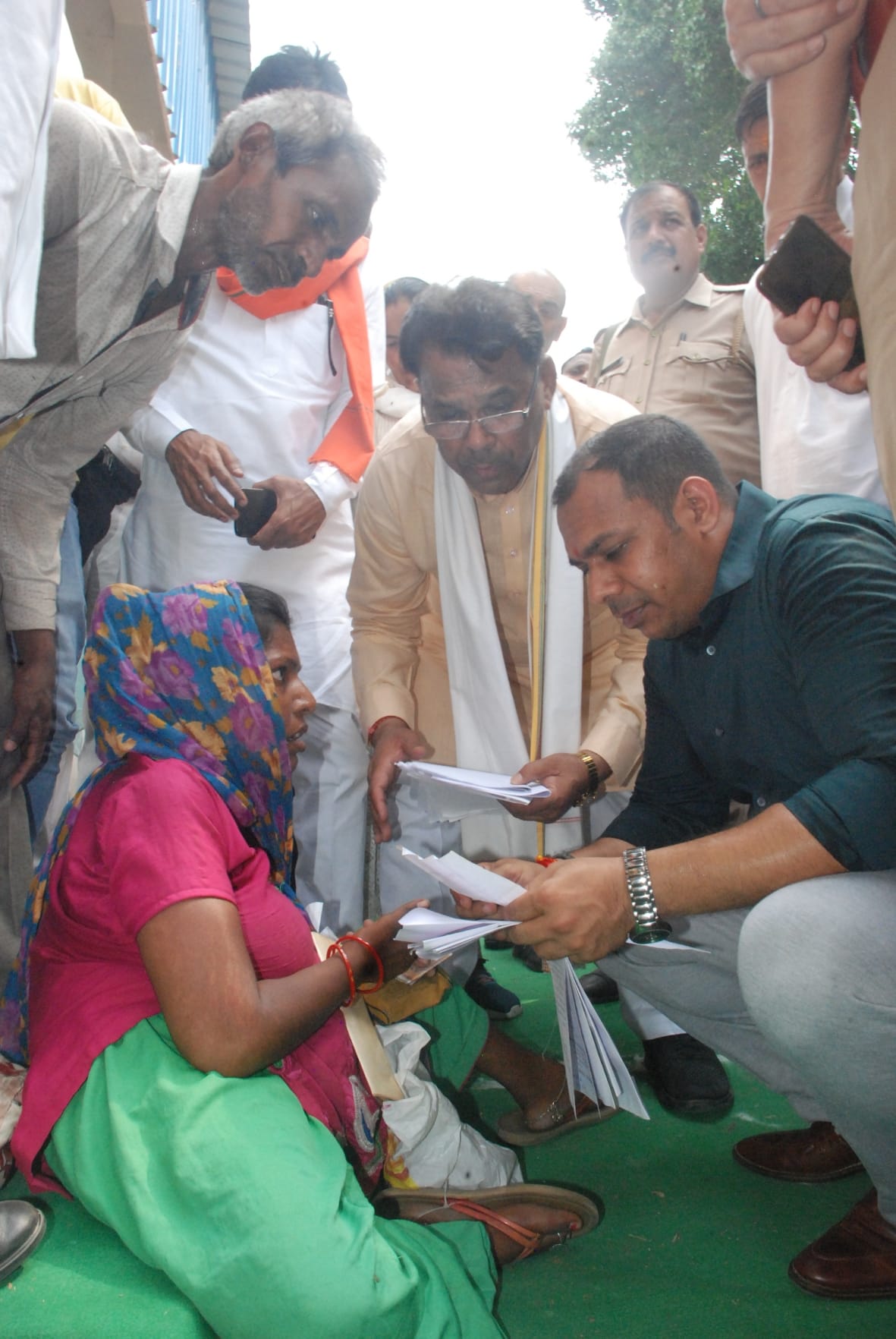The minister sat on the ground and listened to the problems of the disabled