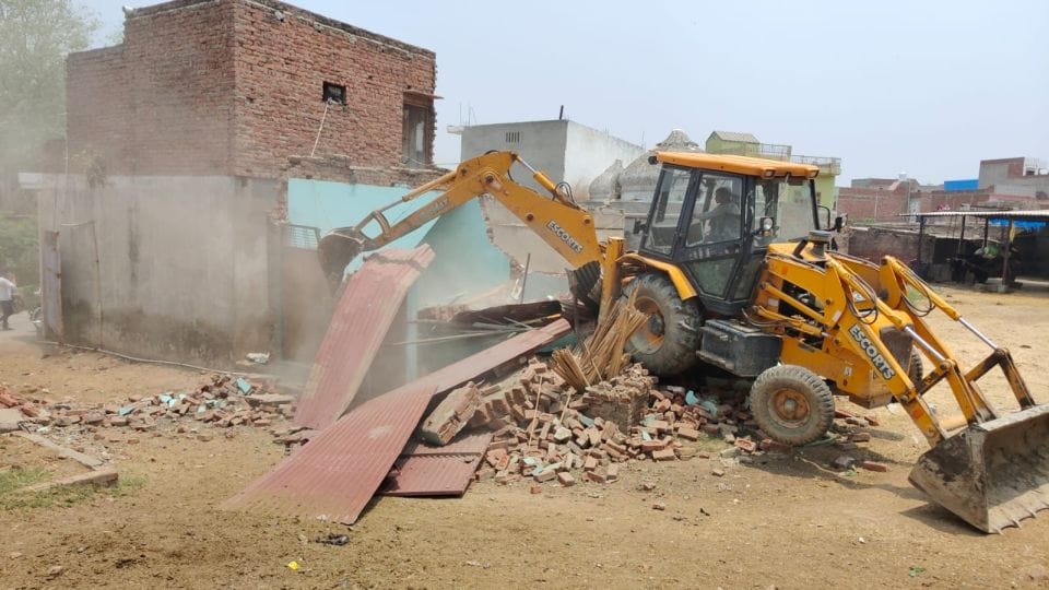Bulldozer demolished illegally built factory and dairy on government land in Jalesar Etah