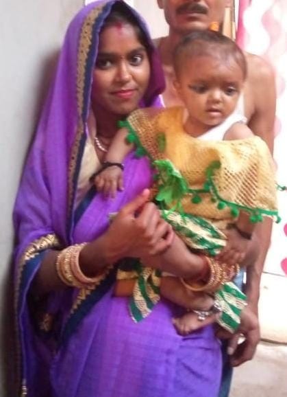 A woman returning with a talisman and a ten-month-old daughter was crushed to death by a truck