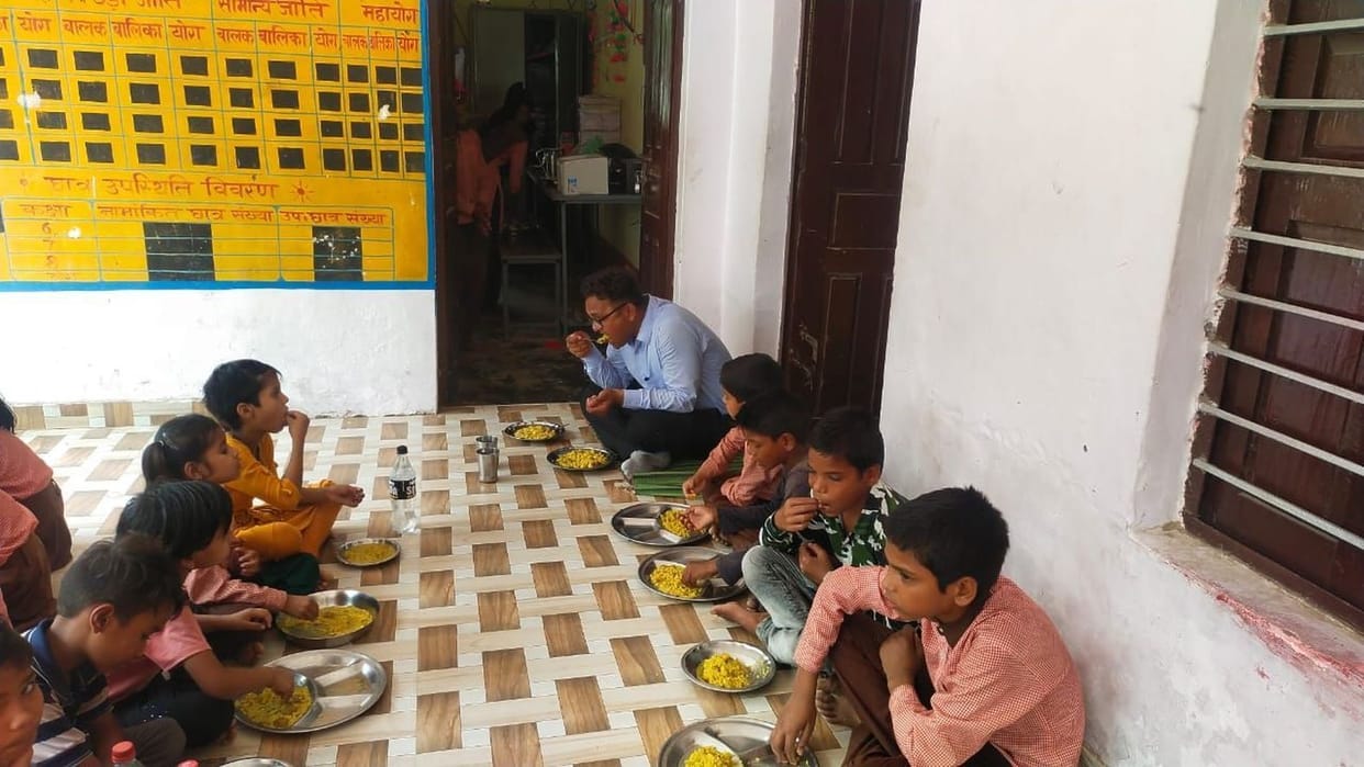 BEO tasted tahri by sitting on the floor with children