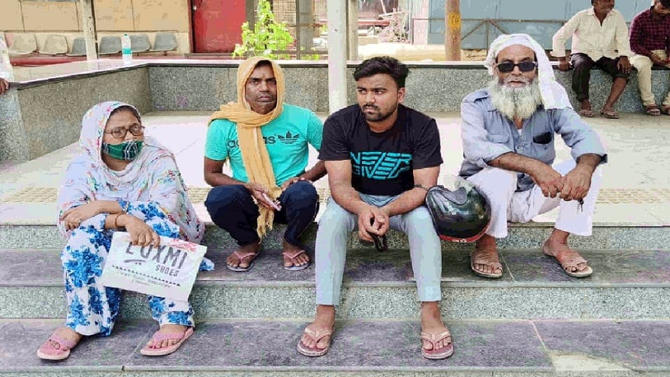 people sitting outside mortuary of sanjay gandhi hospital waiting to get dead bodies of their loved ones