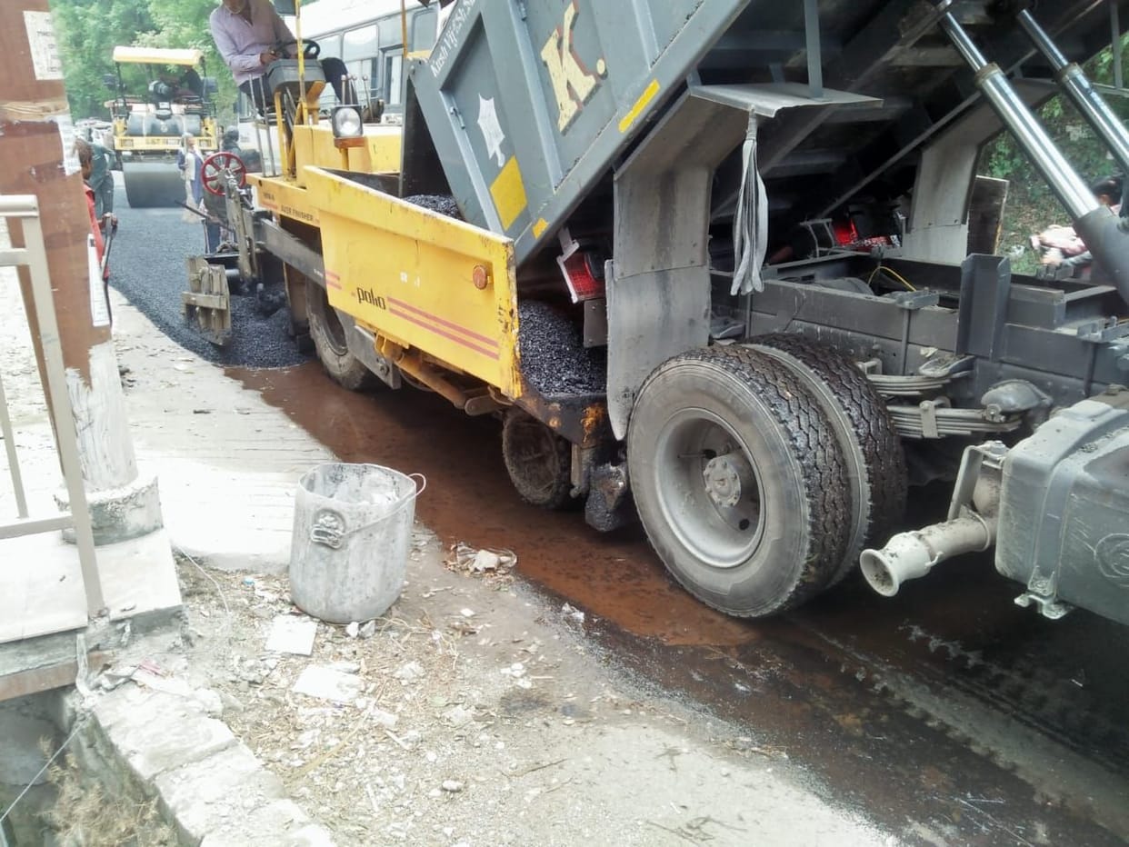 Taring done on a road filled with water