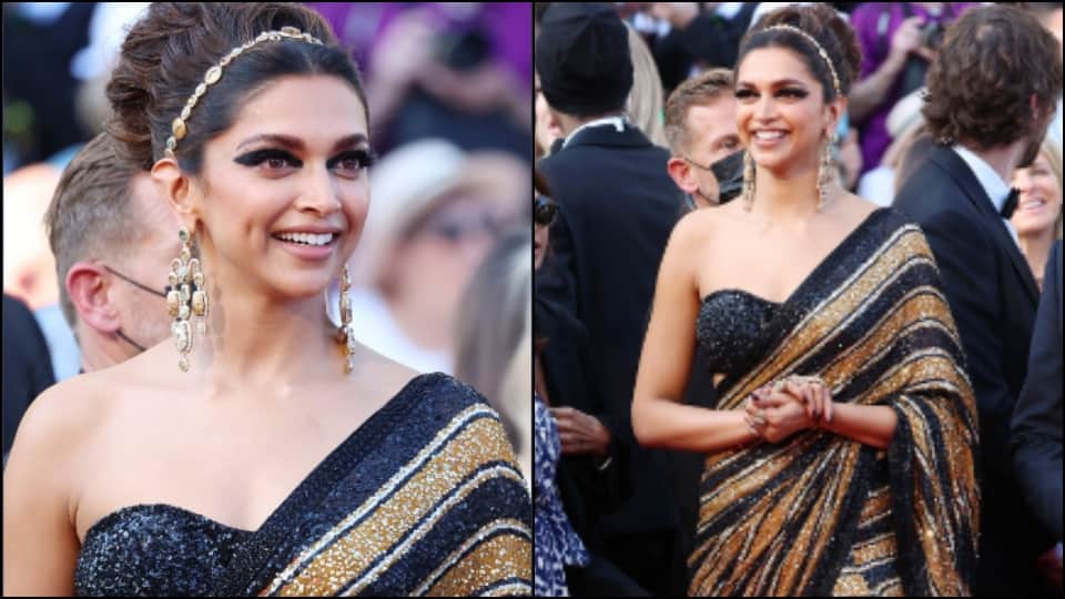 Deepika Padukone wearing a black and golden sari on the red carpet of Cannes Film Festival 2022