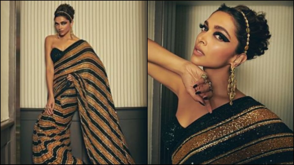 Deepika Padukone wearing a black and golden sari on the red carpet of Cannes Film Festival 2022