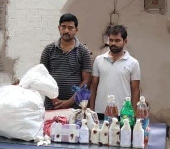 Liquor was sold by mixing water, two salesmen arrested