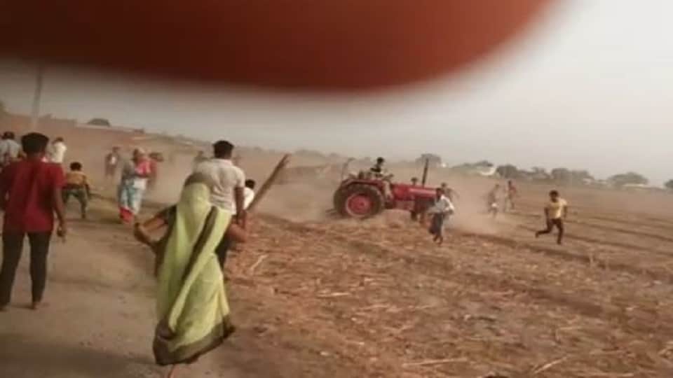 Tractor running to crush the crowd people raining stones agra