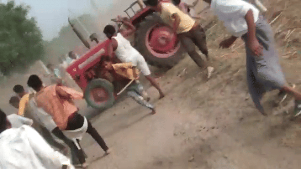 Tractor running to crush the crowd people raining stones agra
