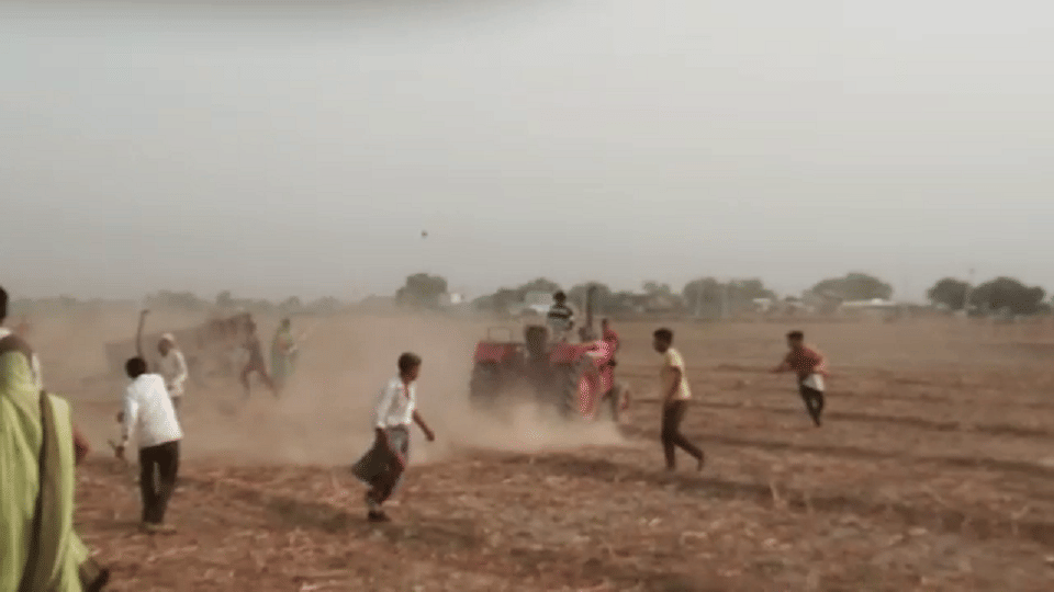Tractor running to crush the crowd people raining stones agra