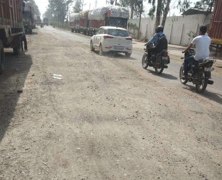 Vehicles parked in front of the factory are inviting accidents