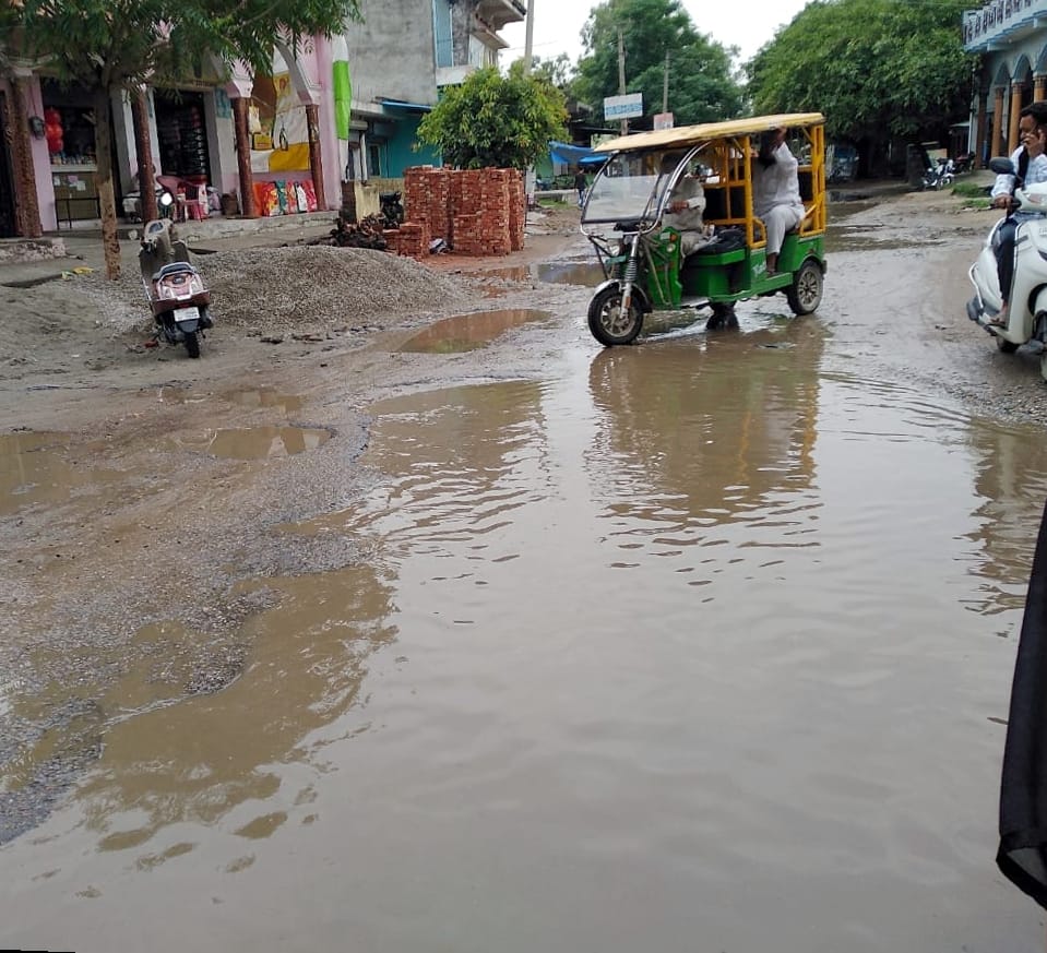 Water logging on the road damaged by rain