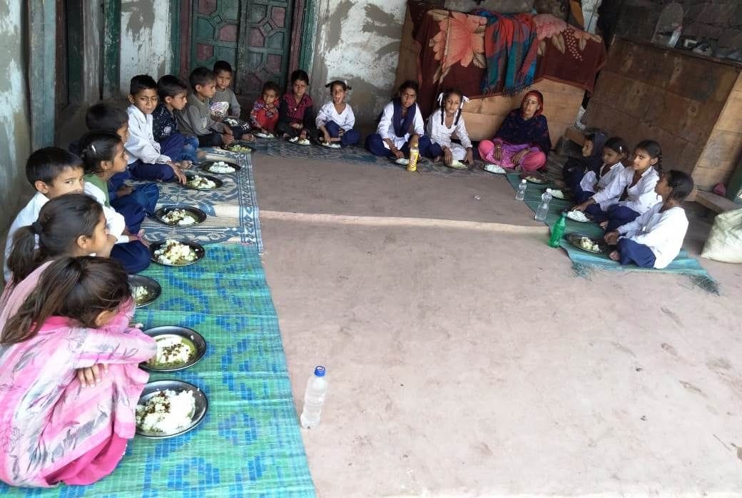 School running in the verandah of the cook who makes mid-day meal