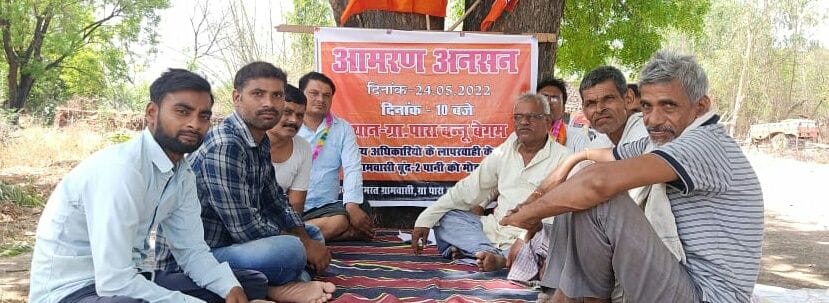 Villagers sitting on fast for water