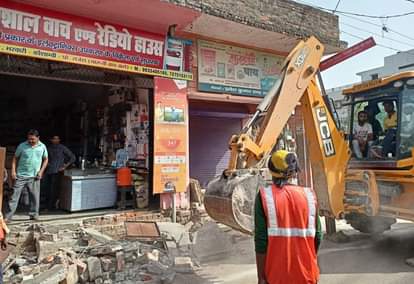 भरवारी कस्बे में अतिक्रमण हटाता जेसीबी