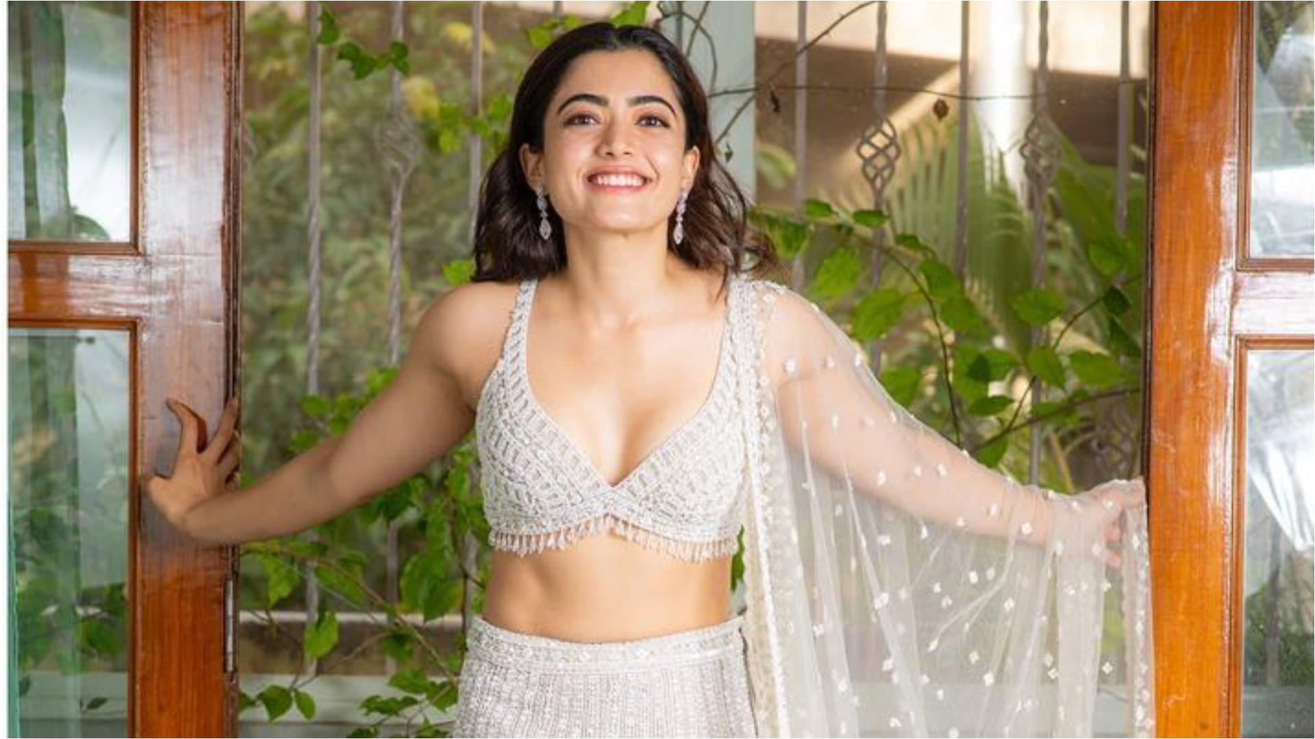 rashmika mandanna show cute smile in silver bralette blouse and lehenga