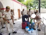 रेलवे स्टेशन पर जांच-पड़ताल करते पुलिस कर्मचारी।
