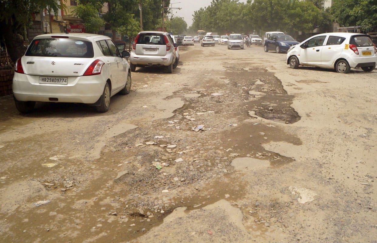 Bad condition of smart city: there are potholes on the roads... walk carefully