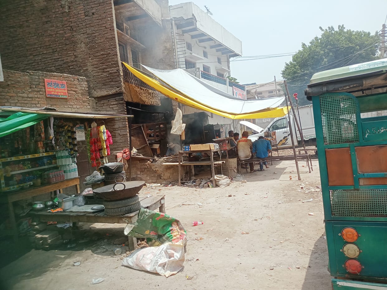 Encroachment being removed on one side, tarpaulin on the other side