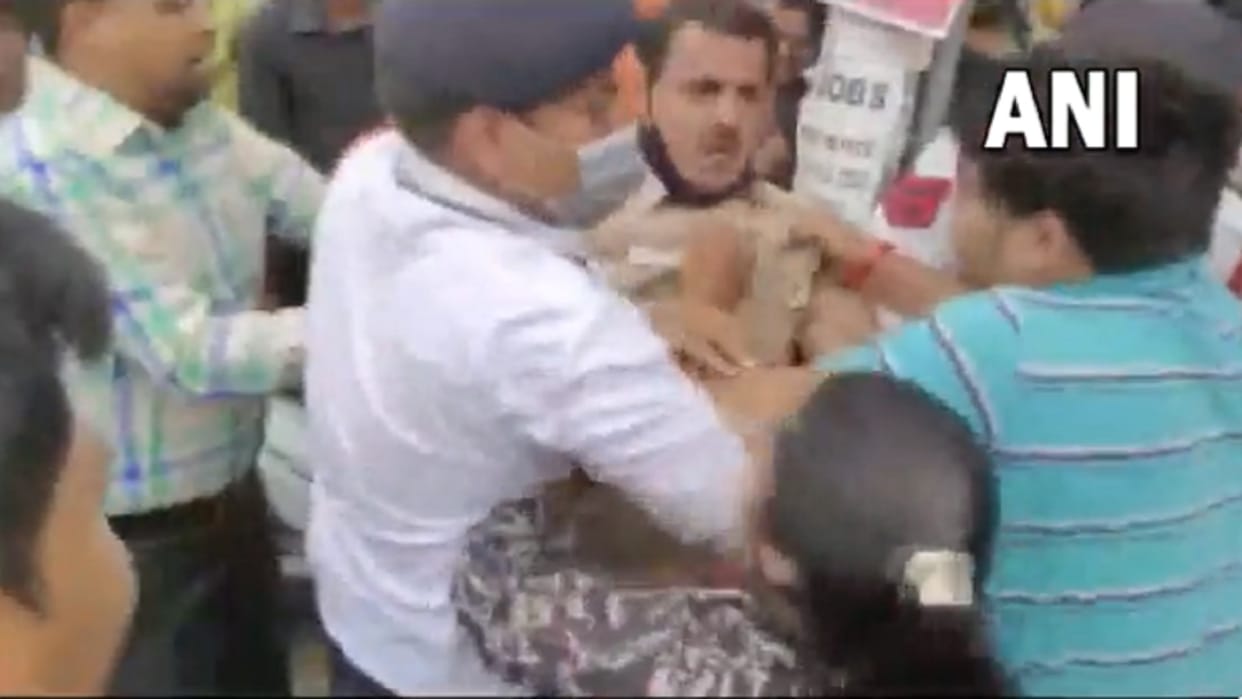 A man and two girls not following traffic rules misbehaved with and manhandled Police personnel