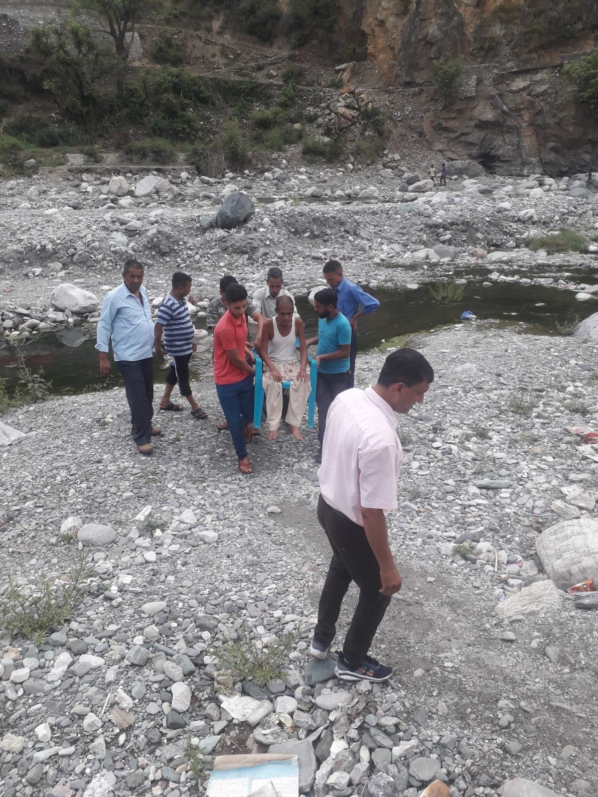 Villagers brought sick patient to the road with the help of chair