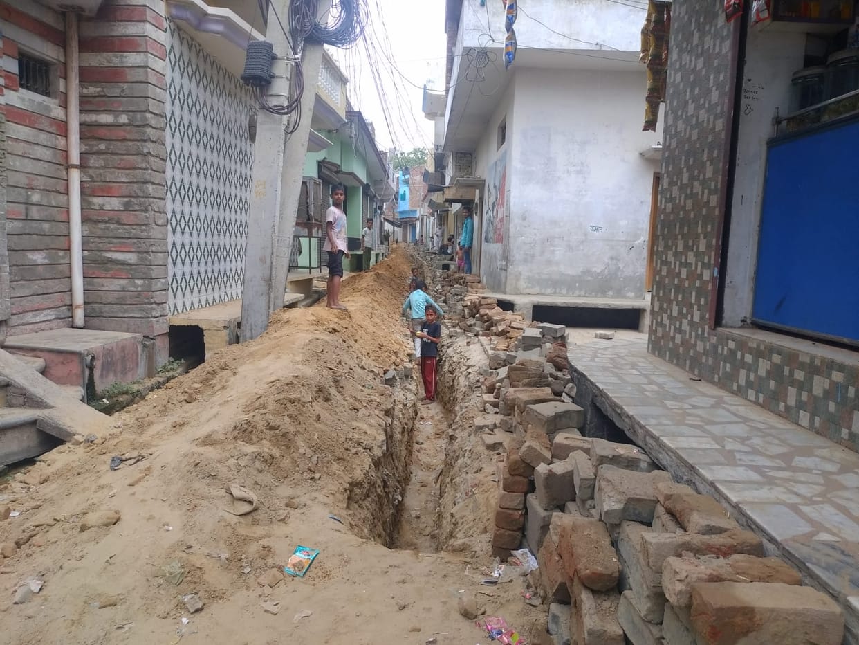 Road dug to lay sewer line, people imprisoned in homes