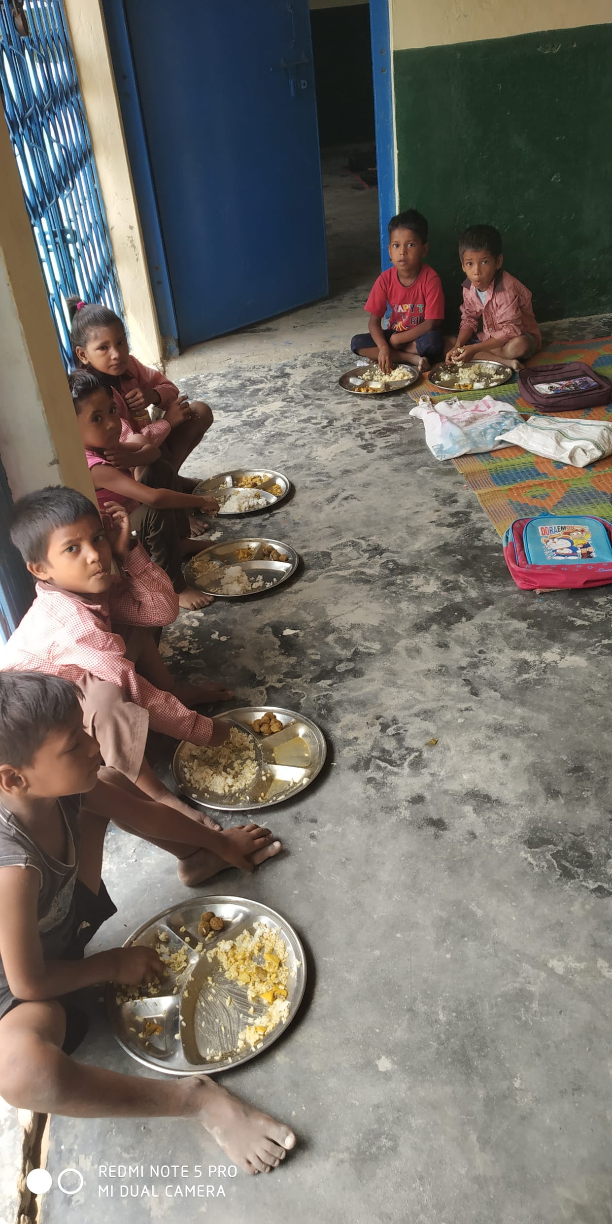 children studying sitting on the ground