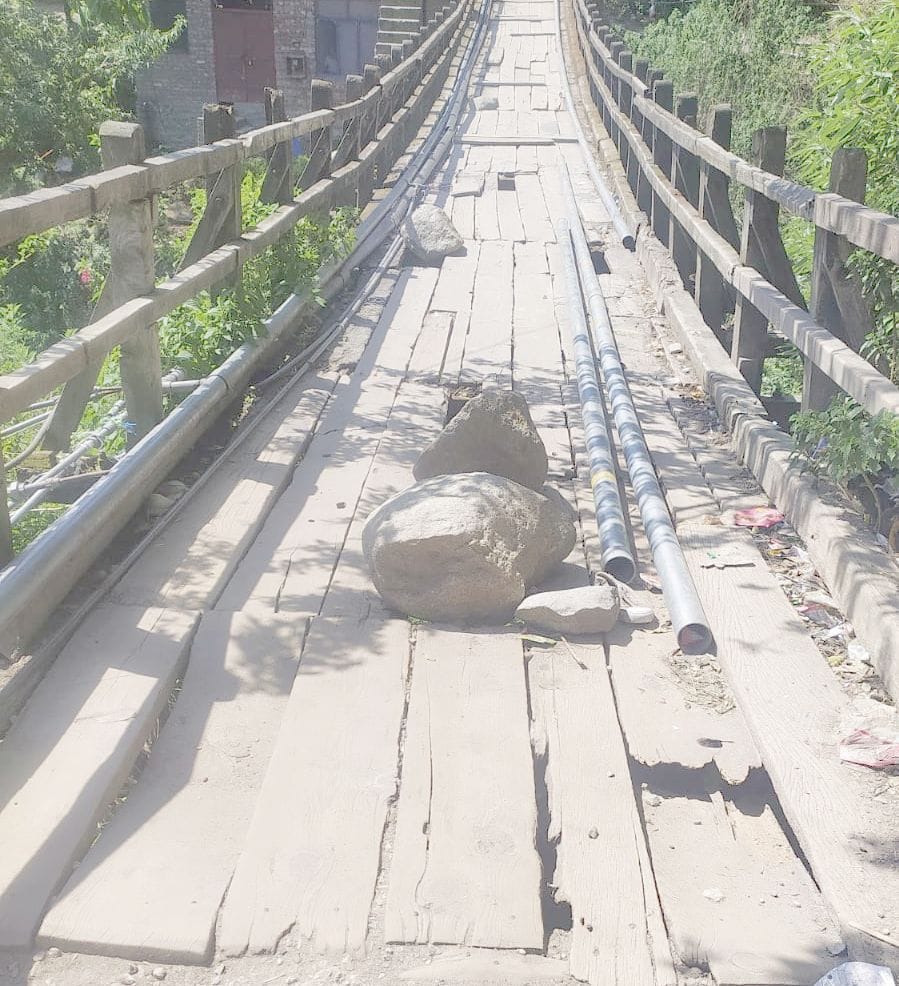 The wooden bridge built on the Bhatalwan drain is in disrepair