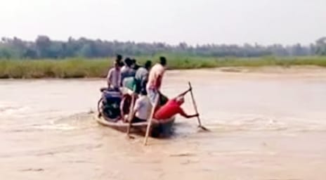 Villagers crossing the river with the help of boat
