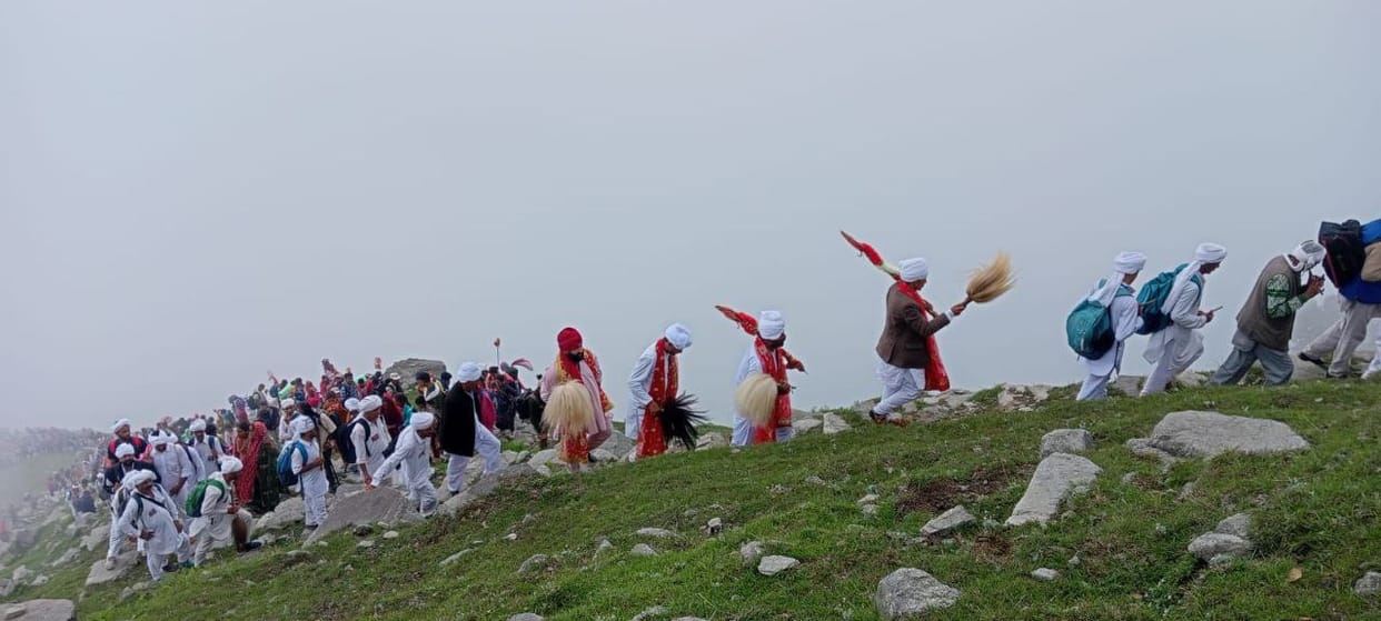 Devotees climbing the mountains on the sound of musical instruments
