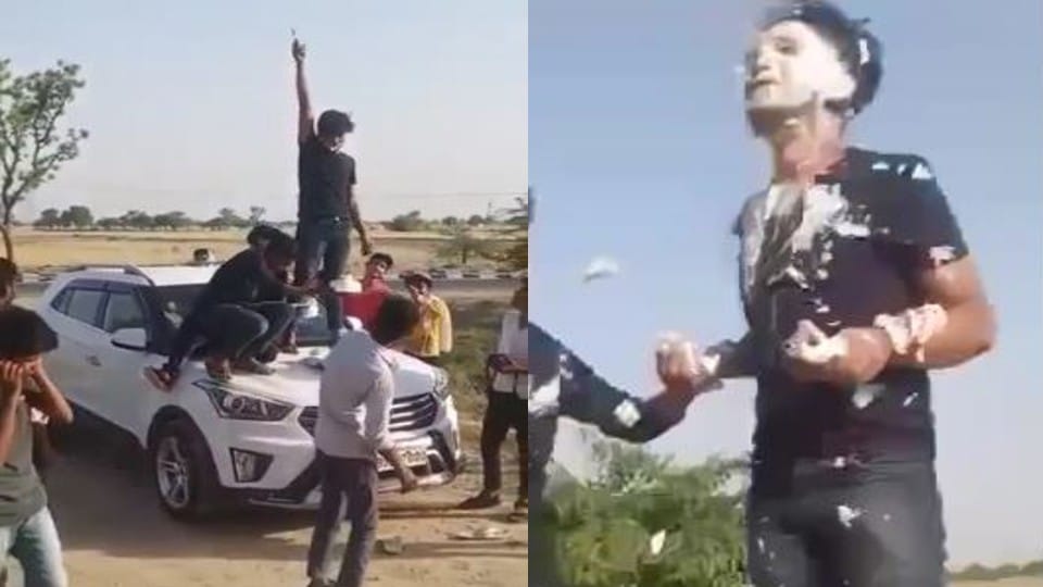 young man cut cake with pistol on bonnet of car in Firozabad