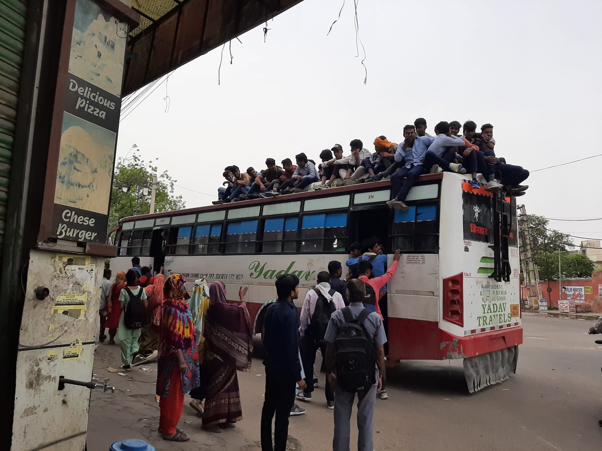 Traveling on the roof of the bus by risking life