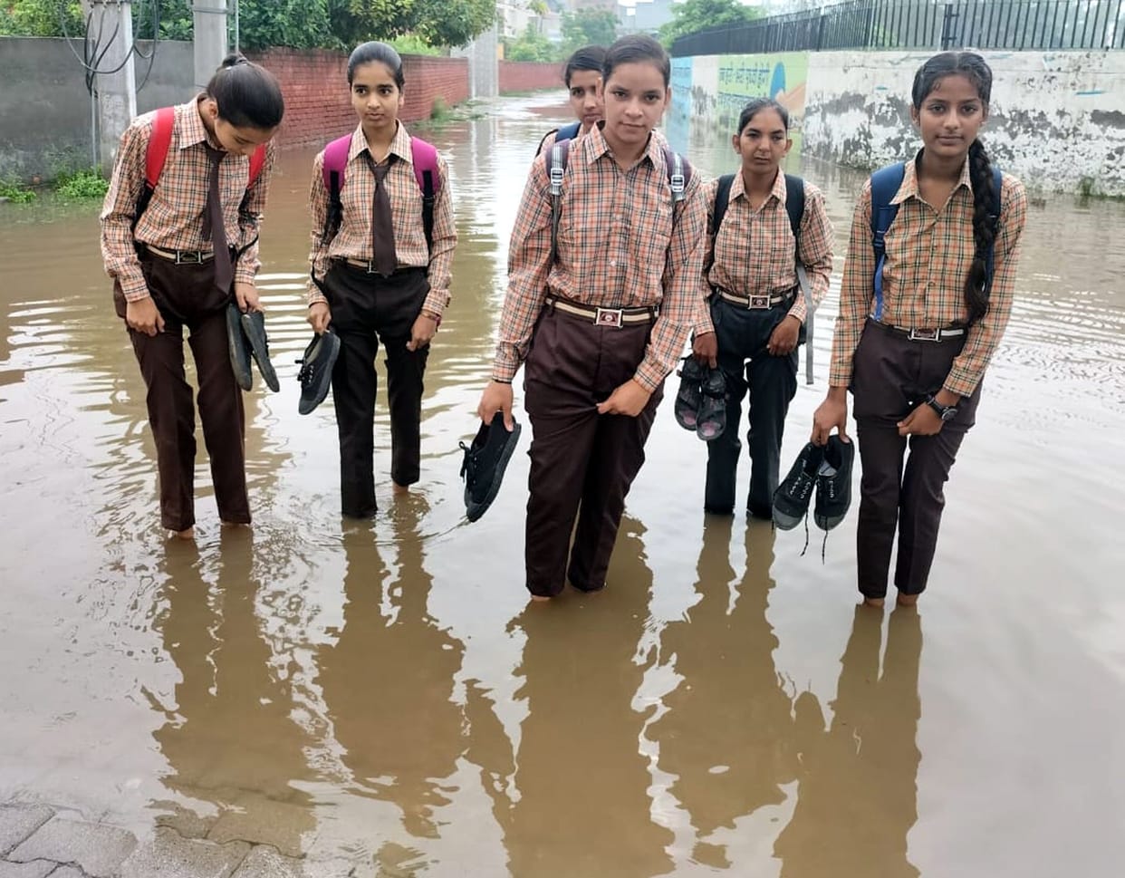How to go to school... when a 'pool' of dirty water is built in front of the gate