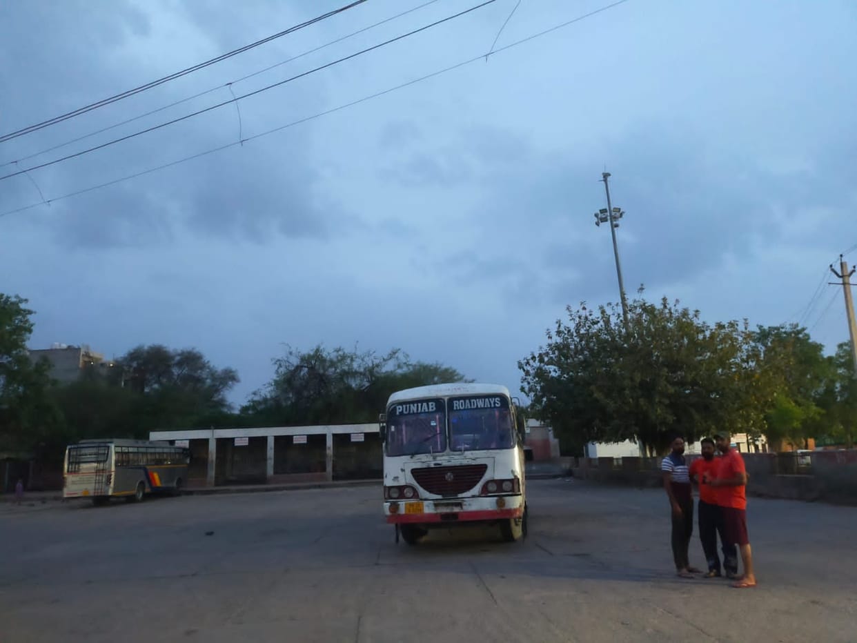 High mast lights off, local bus stand in the dark