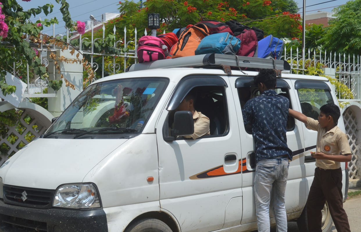 Children filling private vehicles like straw
