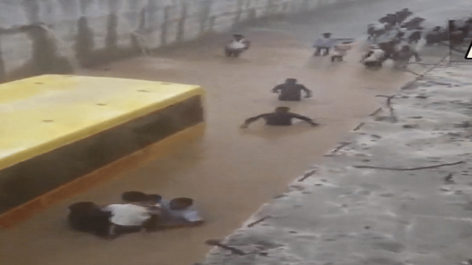 Telangana: School bus, carrying students, partially submerged in a flooded street in Mahbubnagar