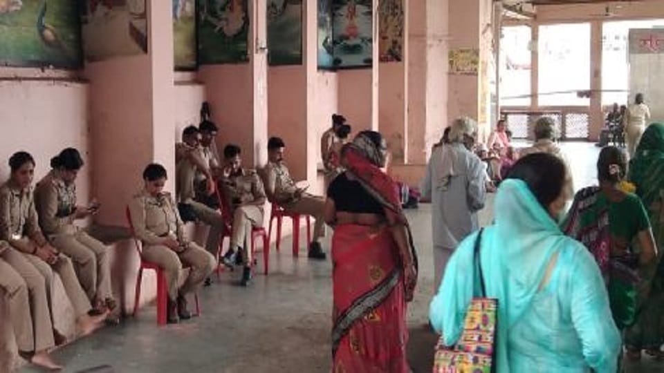 Policemen deployed in security arrangements for devotees coming to Mudiya fair in Govardhan busy in mobile